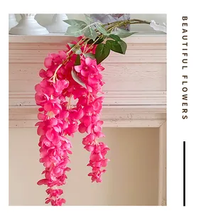 Detail of hanging artificial wisteria flowers in magenta for wedding venue decoration