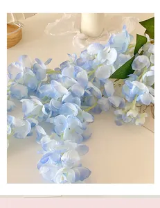 Close-up of artificial blue wisteria flowers with realistic silk petals for wedding decor
