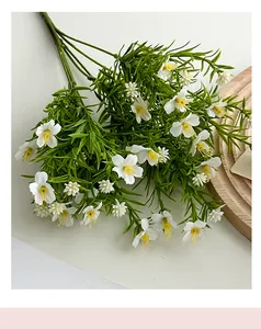 Detail of white artificial chamomile bouquet on a minimalist wooden tray for home decor