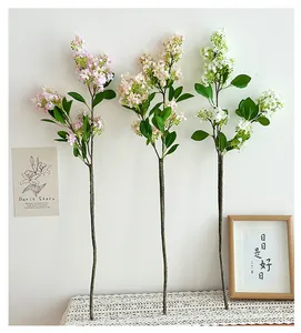 Close-up of artificial lilac stems in pink and white for home table decoration