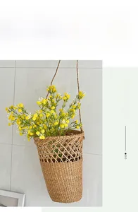 Detail of hanging woven grass basket with small yellow and white artificial flowers