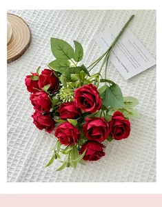 Close-up of 10-head silk red roses on white mesh fabric for wedding home decor