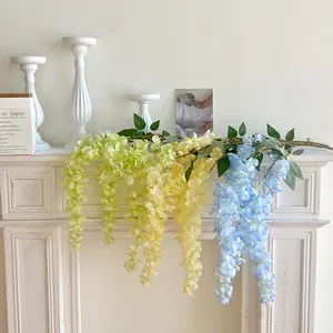Artificial wisteria vines in green, yellow and blue for wedding ceiling decoration