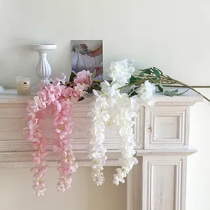 Artificial pink and white wisteria hanging vines for wedding floral decor on white mantel
