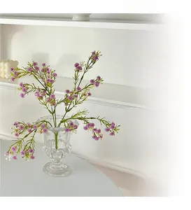 Purple artificial gypsophila in a classic relief glass vase for minimalist home decor