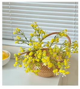 Close-up of artificial yellow flowers in a handmade woven rattan basket for home decor