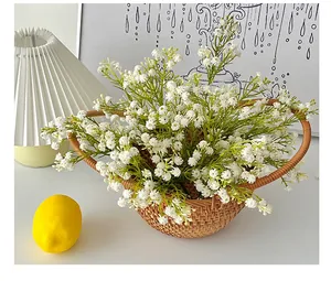 Artificial white gypsophila flowers in a woven wicker basket for home decor
