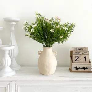 7-fork artificial baby's breath floral arrangement in a cream ceramic vase with handles