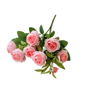 Elegant bouquet of ten pink artificial roses with realistic green leaves on white background
