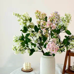 Lifelike lilac bouquet in a white textured ceramic vase for elegant home decor