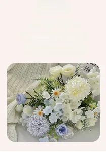 Detail of silk bridal bouquet featuring roses and hydrangeas in soft blue and cream tones