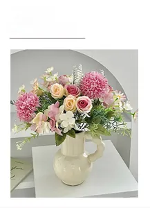 Detailed view of pink rose and hydrangea silk bouquet in modern wavy handle ceramic vase