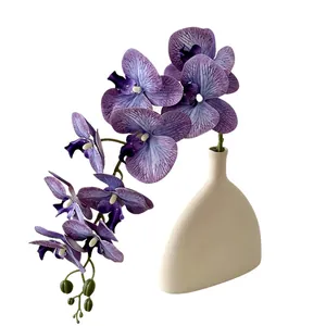 Purple artificial butterfly orchid in a cream ceramic vase for modern home decor