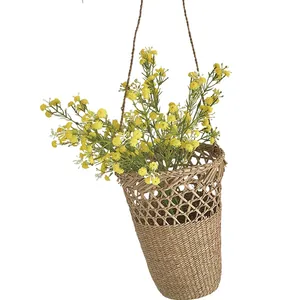 Hanging woven plant basket with yellow artificial flowers for home wall decoration