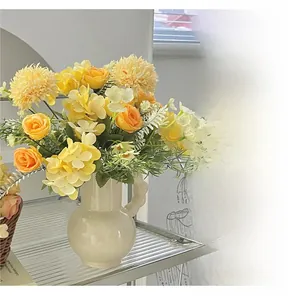 Detailed view of artificial roses and hydrangeas in a white ceramic vase for home decor