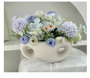 Artificial rose and hydrangea silk flowers in a white modern ceramic vase for home decor