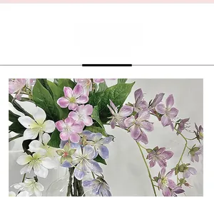 Close-up of 3D printed artificial jasmine flowers with realistic petals in a glass vase
