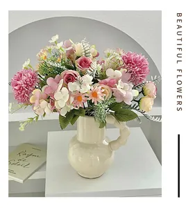 Artistic ceramic vase with pink artificial roses and hydrangeas for home decor