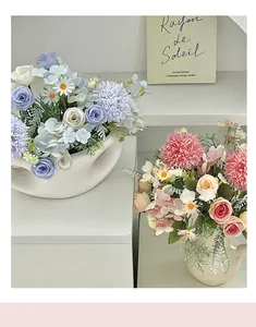 Detail view of blue and pink artificial roses and hydrangeas in ceramic vases