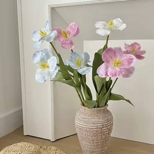 Faux brownie tulip bouquet in light blue, pink, and white inside a ceramic vase