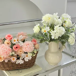 Artificial pink rose and hydrangea floral arrangement in woven basket and ceramic vase
