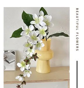 Close-up of white artificial jasmine flowers in a ceramic vase for home decoration