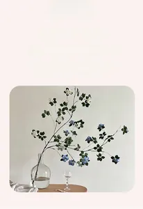 Detail of artificial small flowers in clear glass vase for minimalist home decor
