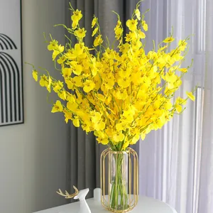 Vibrant yellow dancing orchid silk flower in a gold glass vase for home decor