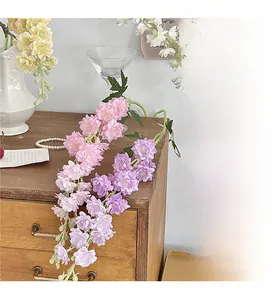 Elegant hanging faux larkspur and violet flowers on a vintage wood drawer for home decor