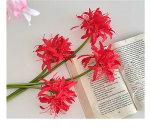 Close-up of red Lycoris Radiata artificial flowers with long stamens on a white background