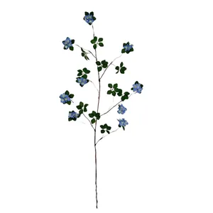 Artificial blue almond blossom stem with green leaves on white background