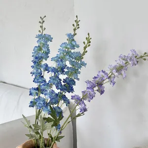 Tall artificial delphinium blue and purple silk flowers in a clay pot for home decor