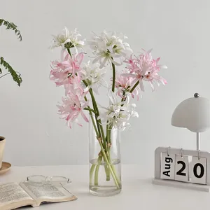 Elegant white and pink spider lily silk flowers in a modern glass vase home decoration