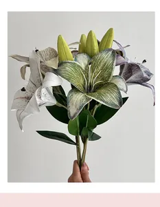 Detailed view of 3D artificial lilies with vibrant petals and natural green buds