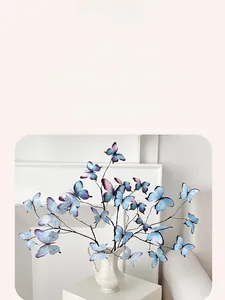 Detail of 3D printed blue butterfly floral arrangement in a white ceramic vase