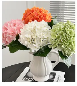 Detail of multi-colored 3D hydrated artificial hydrangea petals in a white ceramic vase