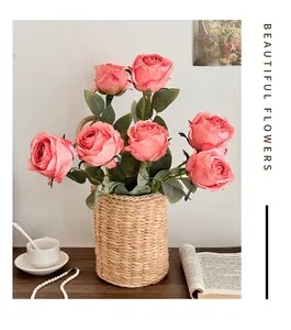 Artificial pink roses bouquet in woven basket for elegant home table decoration