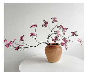 Macro detail of 3D printed butterfly floral decor with fine wire stems in ceramic pot