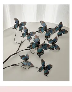 Detailed view of 3D printed blue butterflies on decorative branches for floral arrangements