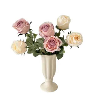 Artificial rose bouquet with gradient pink petals in an elegant white ceramic vase