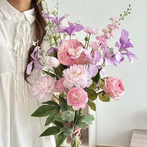 Artistic artificial bouquet with pink peonies and purple irises for home decor photography