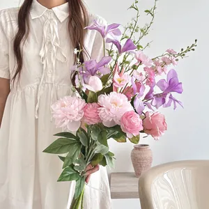 Detail of elegant faux silk bouquet with pink peonies and purple orchids for photography