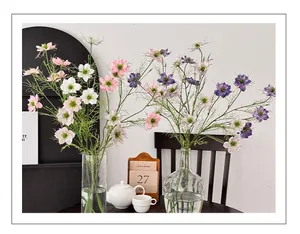 Nahaufnahme künstlicher Nigella-Blumen in Glasvasen für ästhetische Dekoration