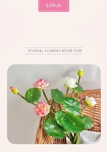 Artificial pink and white lotus flowers with green leaves in a woven basket