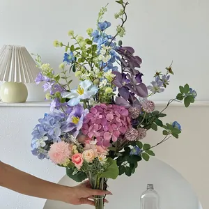Close-up of mixed artificial bouquet with pink roses, hydrangeas and blue larkspur
