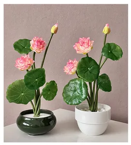 Close-up of artificial lotus bonsai set with ceramic pots and pink water lily flowers