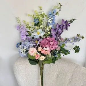 Detailed arrangement of pastel hydrangeas and orchids for wedding photography props