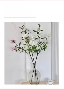 Macro shot of artificial white and pink flower bouquet in a glass vase for home decor