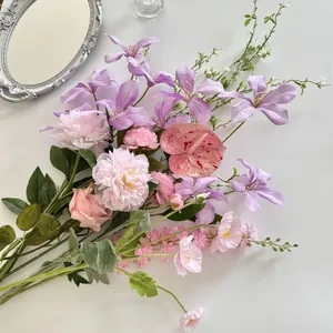 Flat lay of pink roses and purple lilies artificial flower set for photography background