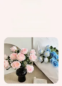 Detailed view of pink and blue silk roses in a modern vase for home table decoration